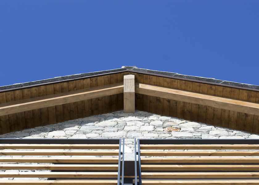 Wooden chalet in Chamois - Exposed wooden roof, ventilated stone façade and iron and wooden balconies